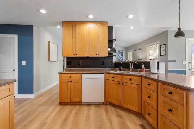 a kitchen with stainless steel appliances granite countertop a sink and cabinets