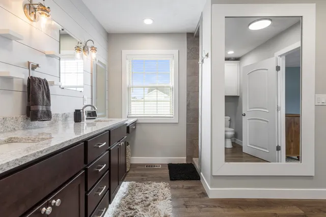 a bathroom with a granite countertop sink mirror and double