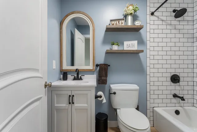 a bathroom with a sink a toilet and shower