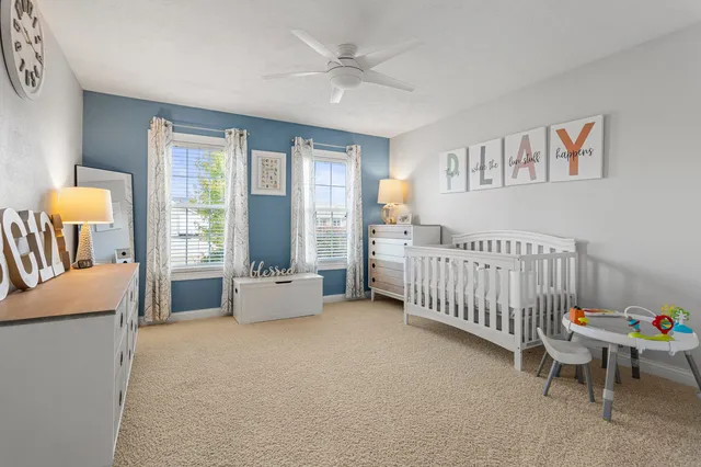 a bedroom with furniture and a large window