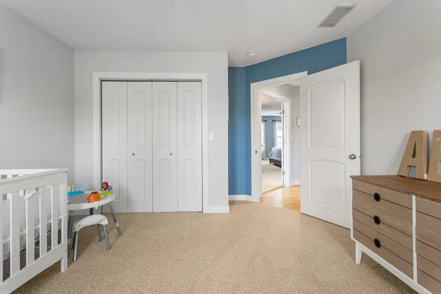 a hallway with a baby crib and a dresser