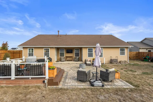 a view of a house with swimming pool and sitting area