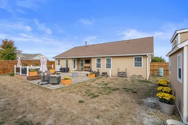 a wooden bench sitting in front of a house