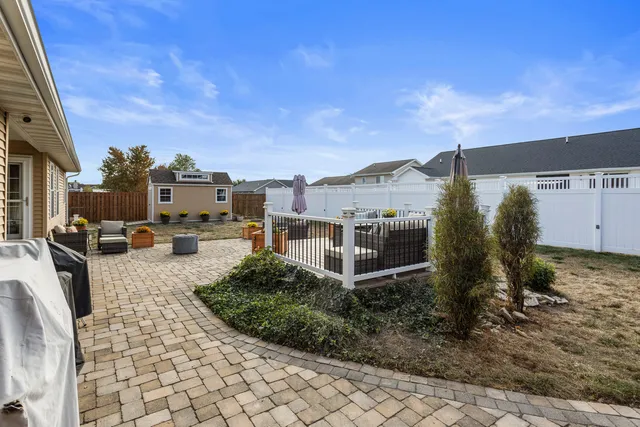 a view of a house with backyard and sitting area