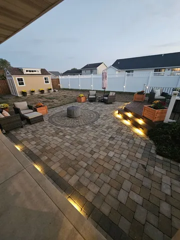 a view of a house with backyard and sitting area