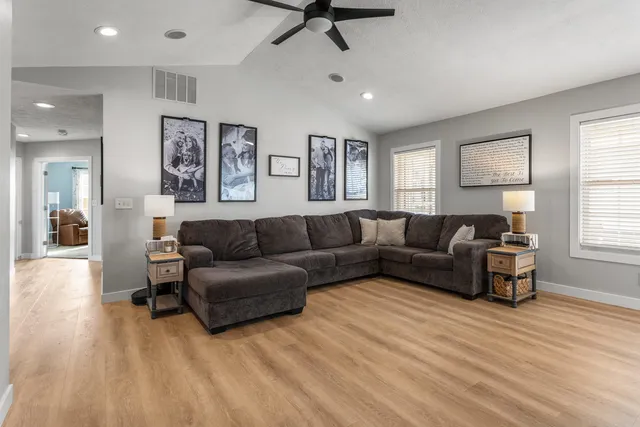 a living room with furniture and a wooden floor