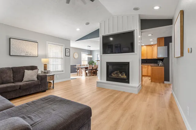 a living room with furniture and a wooden floor