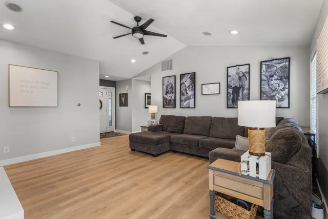 a living room with furniture and a wooden floor