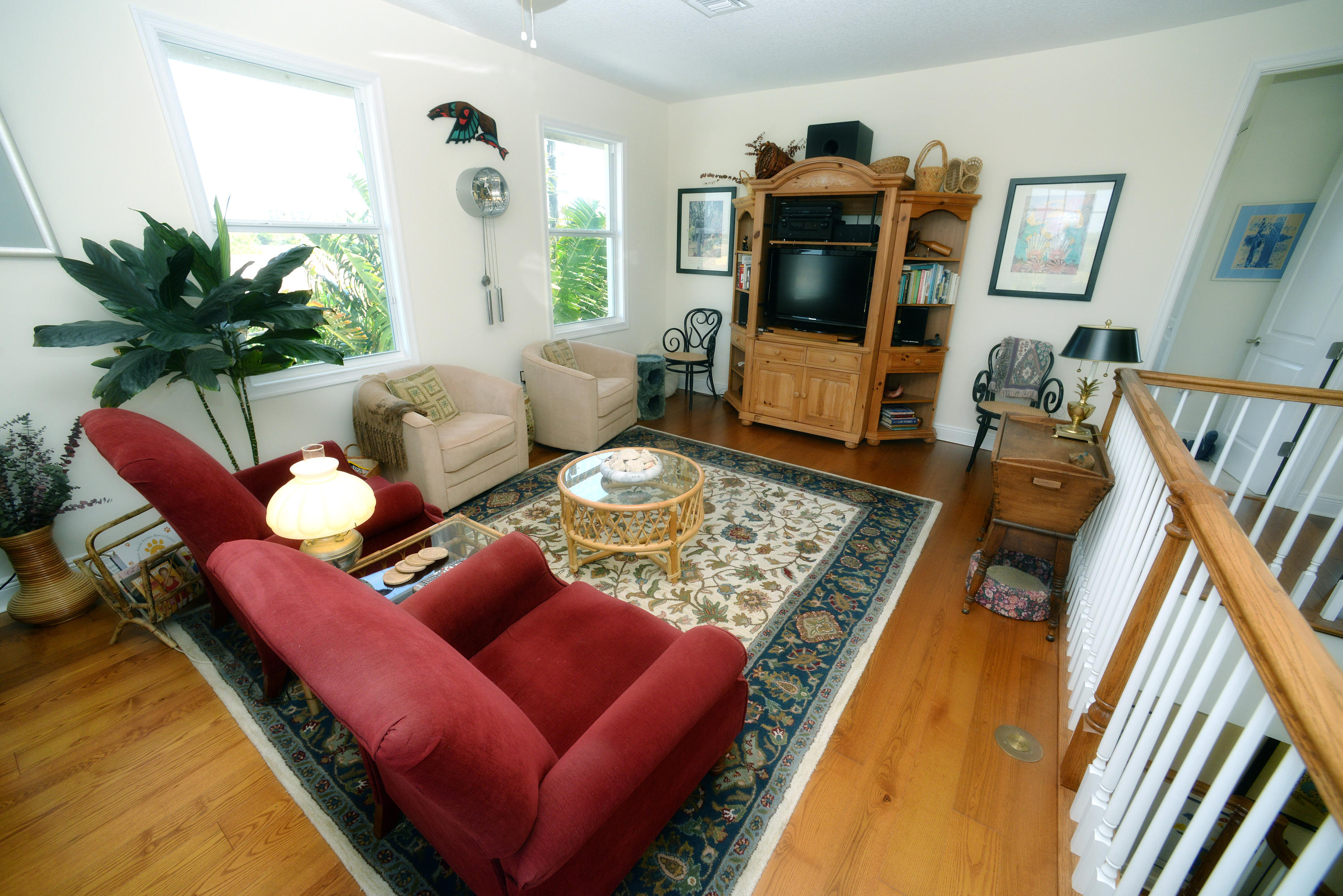 481 Olympus Drive, Unit 201 Juno Beach, FL 33408 - Photo 11 of 23 a living room with furniture and a flat screen tv