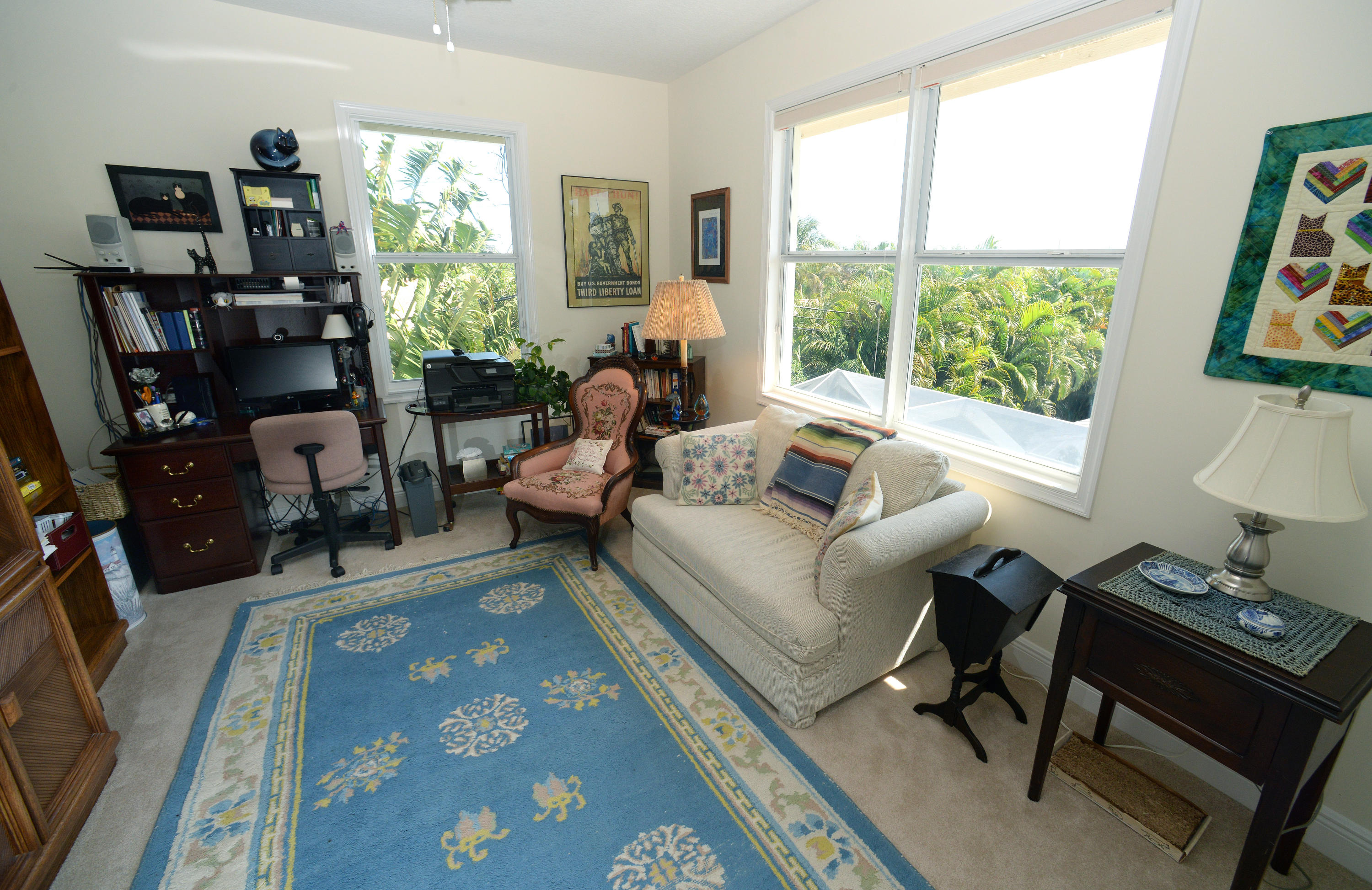 481 Olympus Drive, Unit 201 Juno Beach, FL 33408 - Photo 13 of 23 a living room with furniture and a window