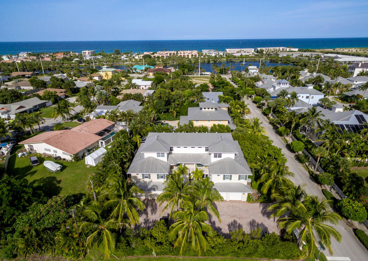 481 Olympus Drive, Unit 201 Juno Beach, FL 33408 - Photo 15 of 23 an aerial view of residential building with outdoor space