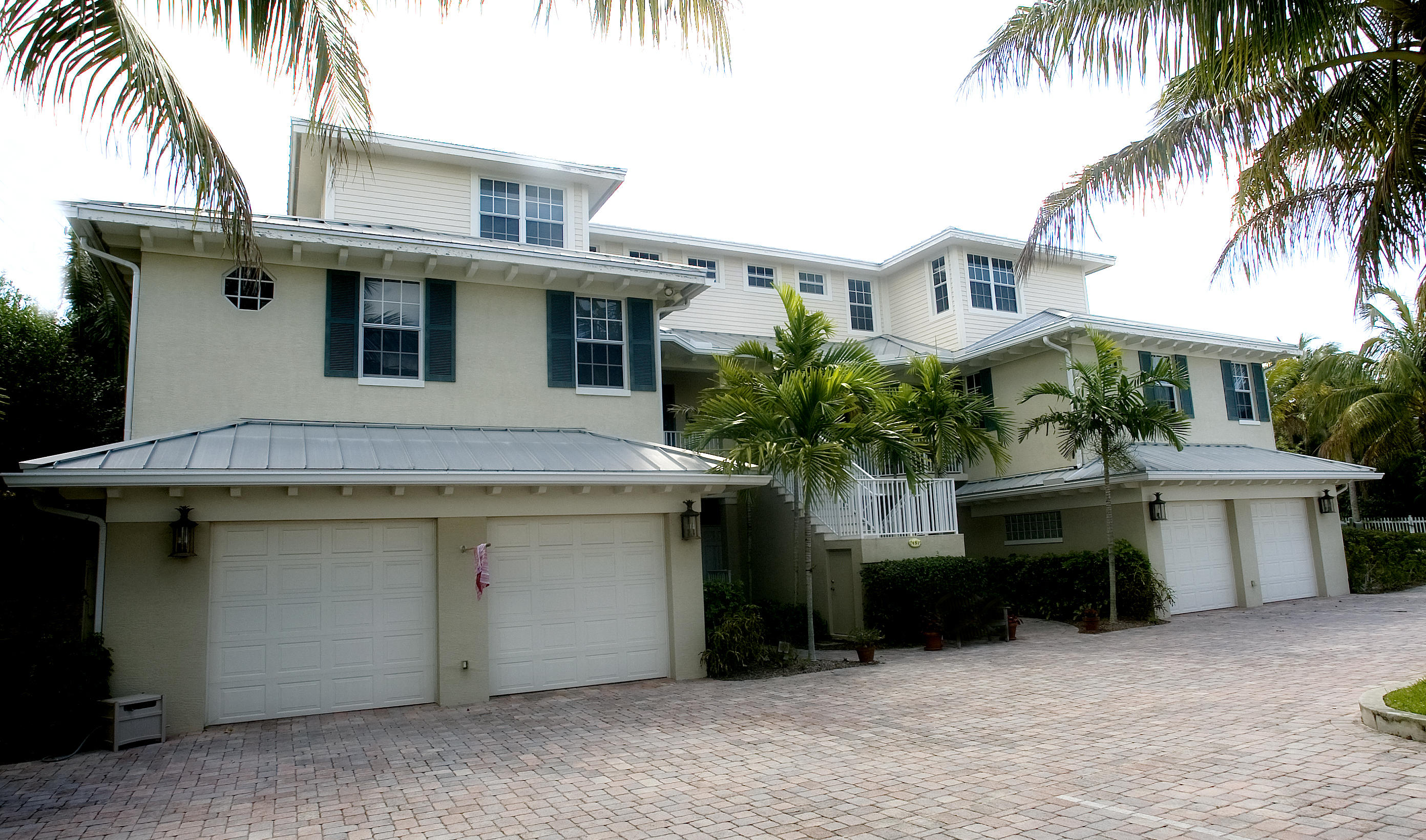 481 Olympus Drive, Unit 201 Juno Beach, FL 33408 - Photo 2 of 23 a front view of a house with a garage