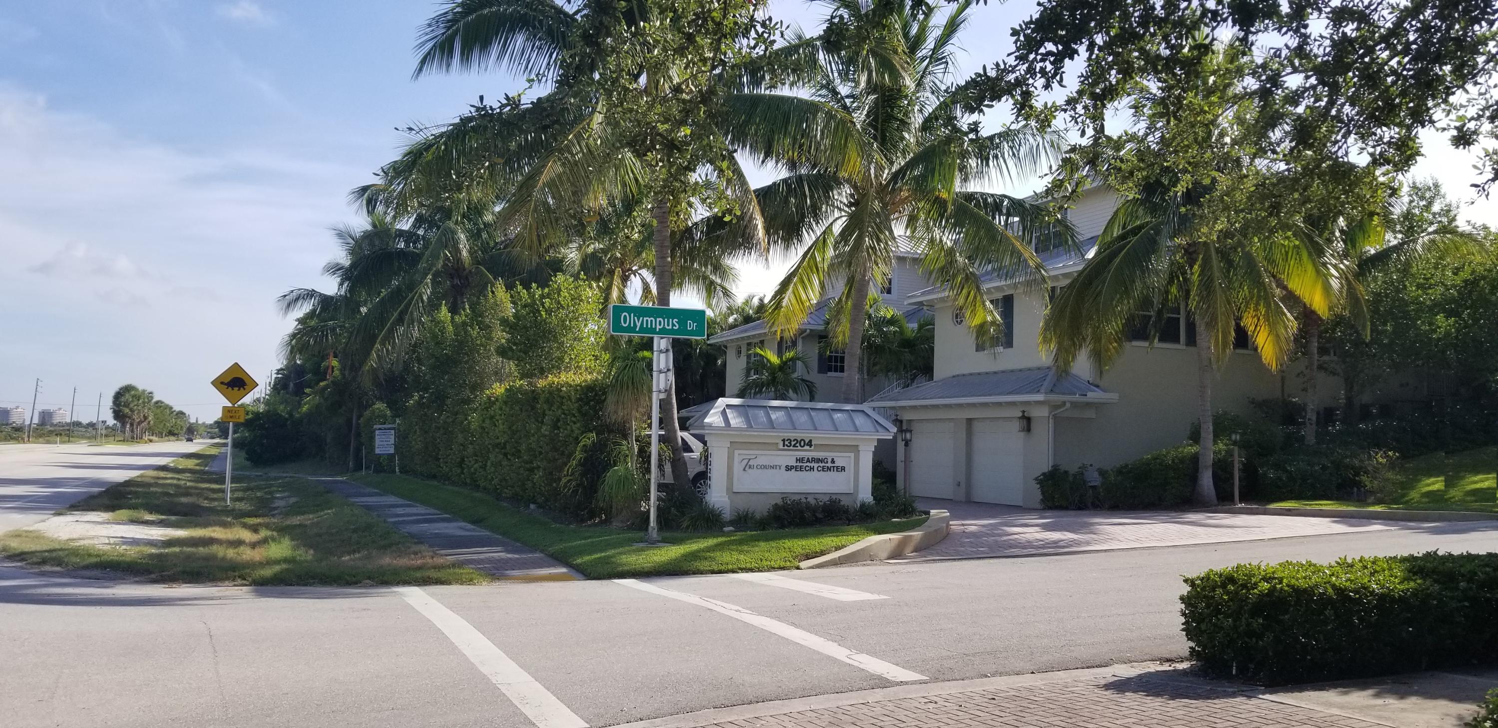 481 Olympus Drive, Unit 201 Juno Beach, FL 33408 - Photo 23 of 23 a view of a house with a street