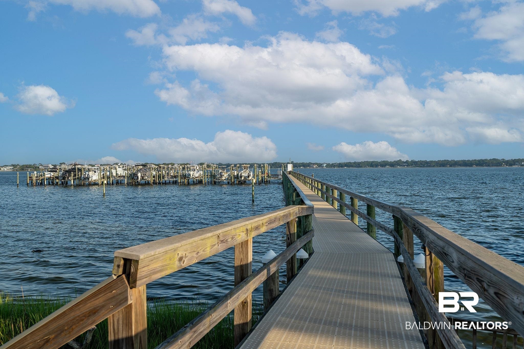 14500 River Road, Unit 305 Pensacola, FL 32507 - Photo 41 of 42 Expansive waterside pier featuring wood railings and composite decking