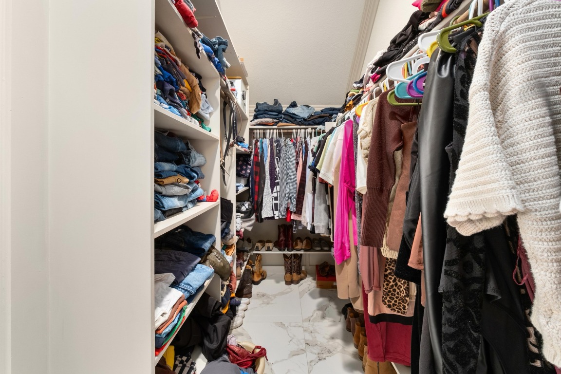 7709 Jacobean Way Austin, TX 78724 - Photo 14 of 23 a view of walk in closet with clothes and shoes