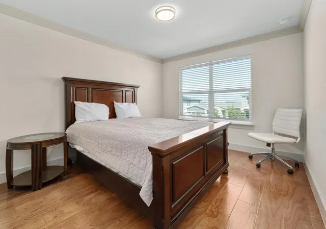 a bedroom with a bed and a desk