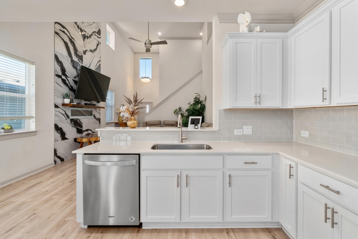 7709 Jacobean Way Austin, TX 78724 - Photo 8 of 23 a kitchen with white cabinets and a sink