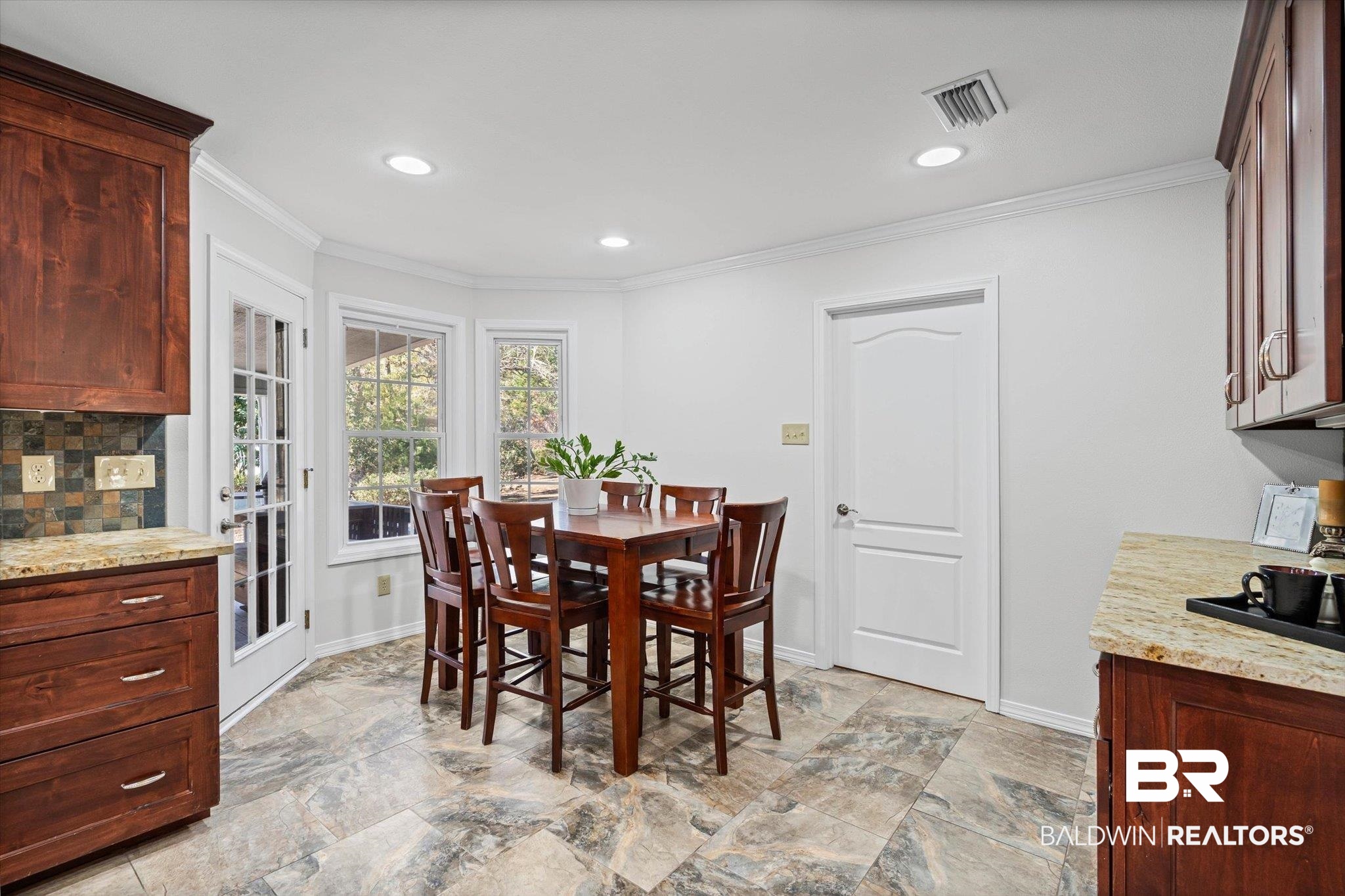 31369 Blakeley Way Daphne, AL 36527 - Photo 6 of 38 Dining space featuring recessed lighting, ornamental molding, and light stone finish flooring