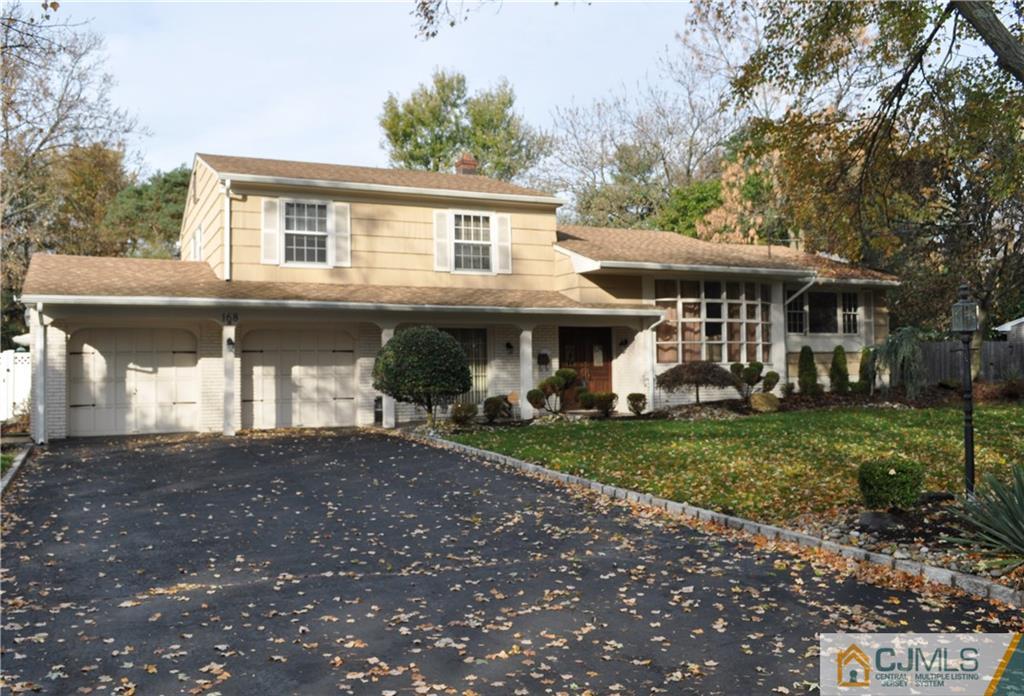 168 Colonia Road Colonia, NJ 07067 - Photo 1 of 23 a front view of a house with garden