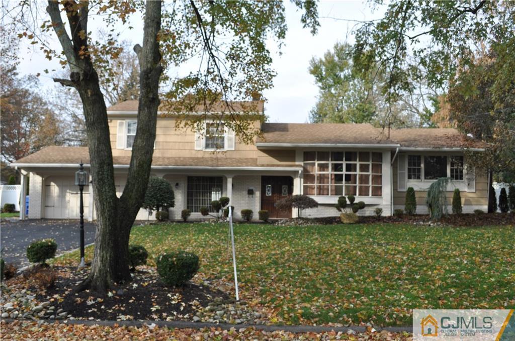 168 Colonia Road Colonia, NJ 07067 - Photo 2 of 23 a front view of a house with a garden