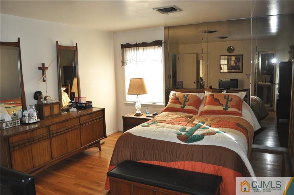 168 Colonia Road Colonia, NJ 07067 - Photo 15 of 23 a bedroom with a bed and wooden floor