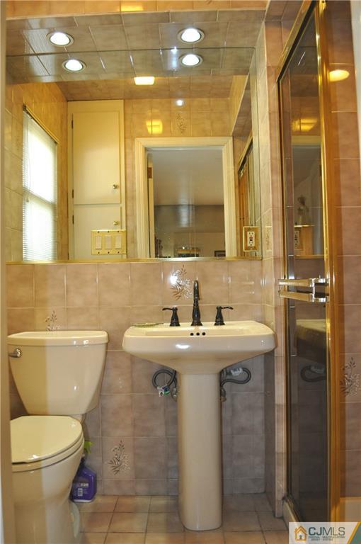 168 Colonia Road Colonia, NJ 07067 - Photo 16 of 23 a bathroom with a toilet sink and mirror