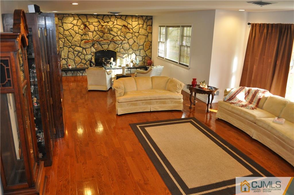 168 Colonia Road Colonia, NJ 07067 - Photo 4 of 23 a living room with furniture and a fireplace