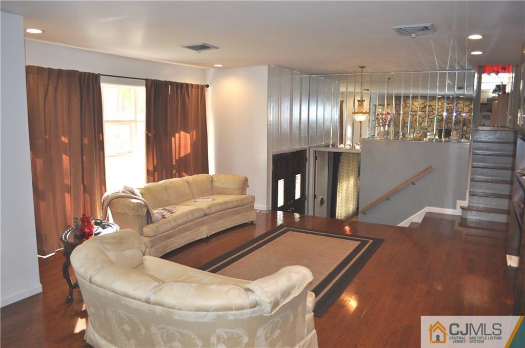 168 Colonia Road Colonia, NJ 07067 - Photo 6 of 23 a living room with furniture and a flat screen tv