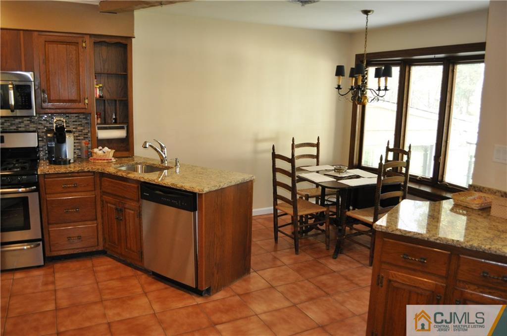 168 Colonia Road Colonia, NJ 07067 - Photo 9 of 23 a kitchen with a sink refrigerator and cabinets