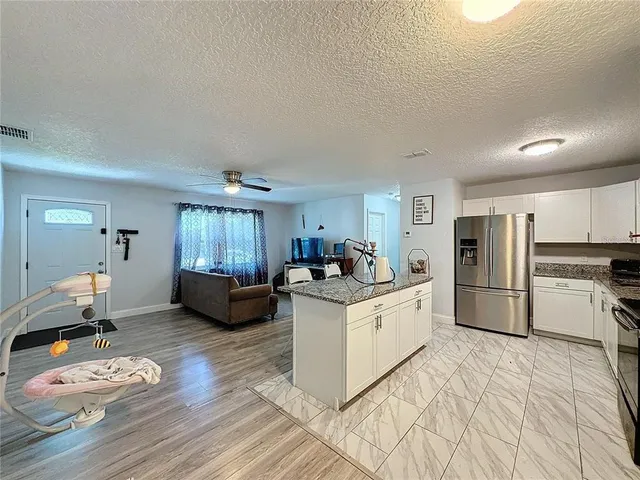 a kitchen with a sink appliances and cabinets