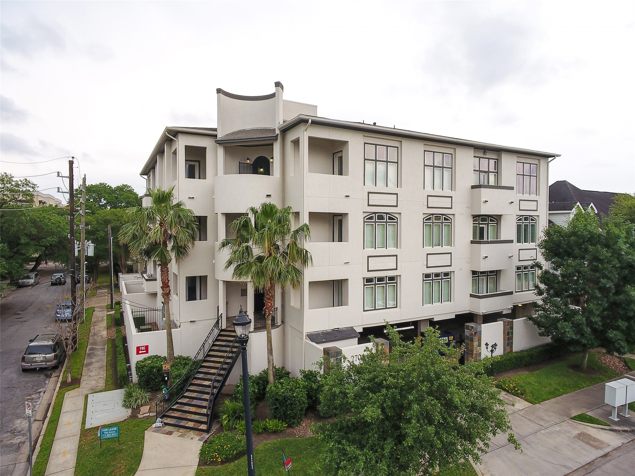 2701 Helena Street, Unit 302 Houston, TX 77006 - Photo 14 of 14 a front view of a residential apartment building with a yard