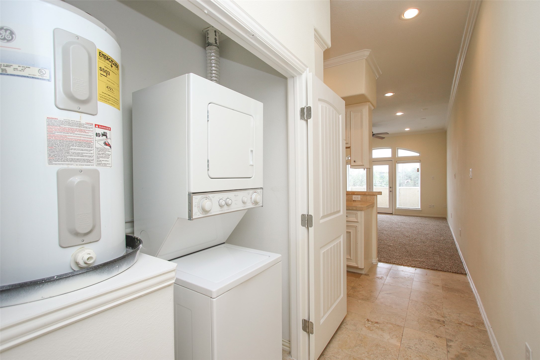 2701 Helena Street, Unit 302 Houston, TX 77006 - Photo 7 of 14 a kitchen with white cabinets and refrigerator