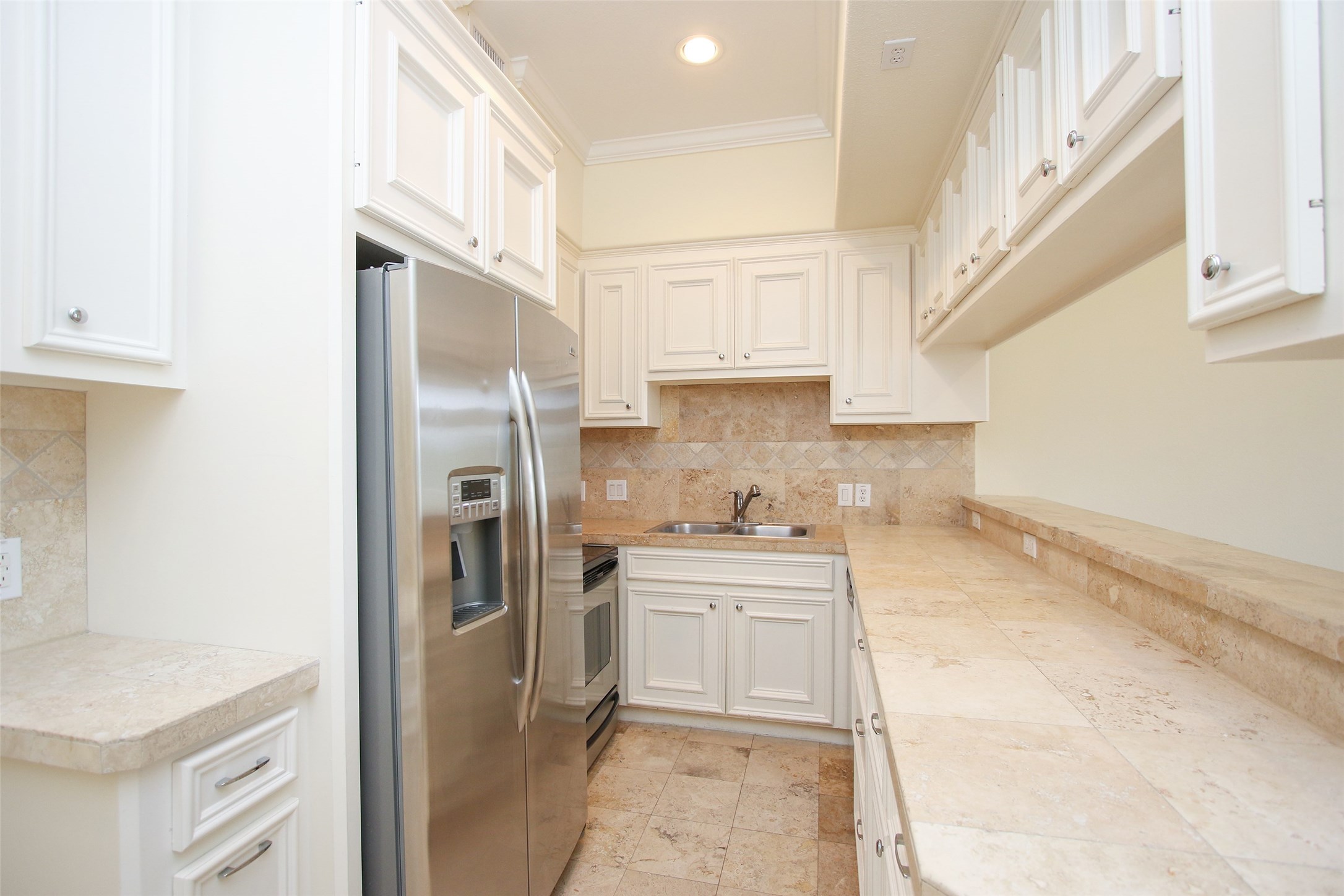 2701 Helena Street, Unit 302 Houston, TX 77006 - Photo 8 of 14 a kitchen with stainless steel appliances a refrigerator sink and cabinets