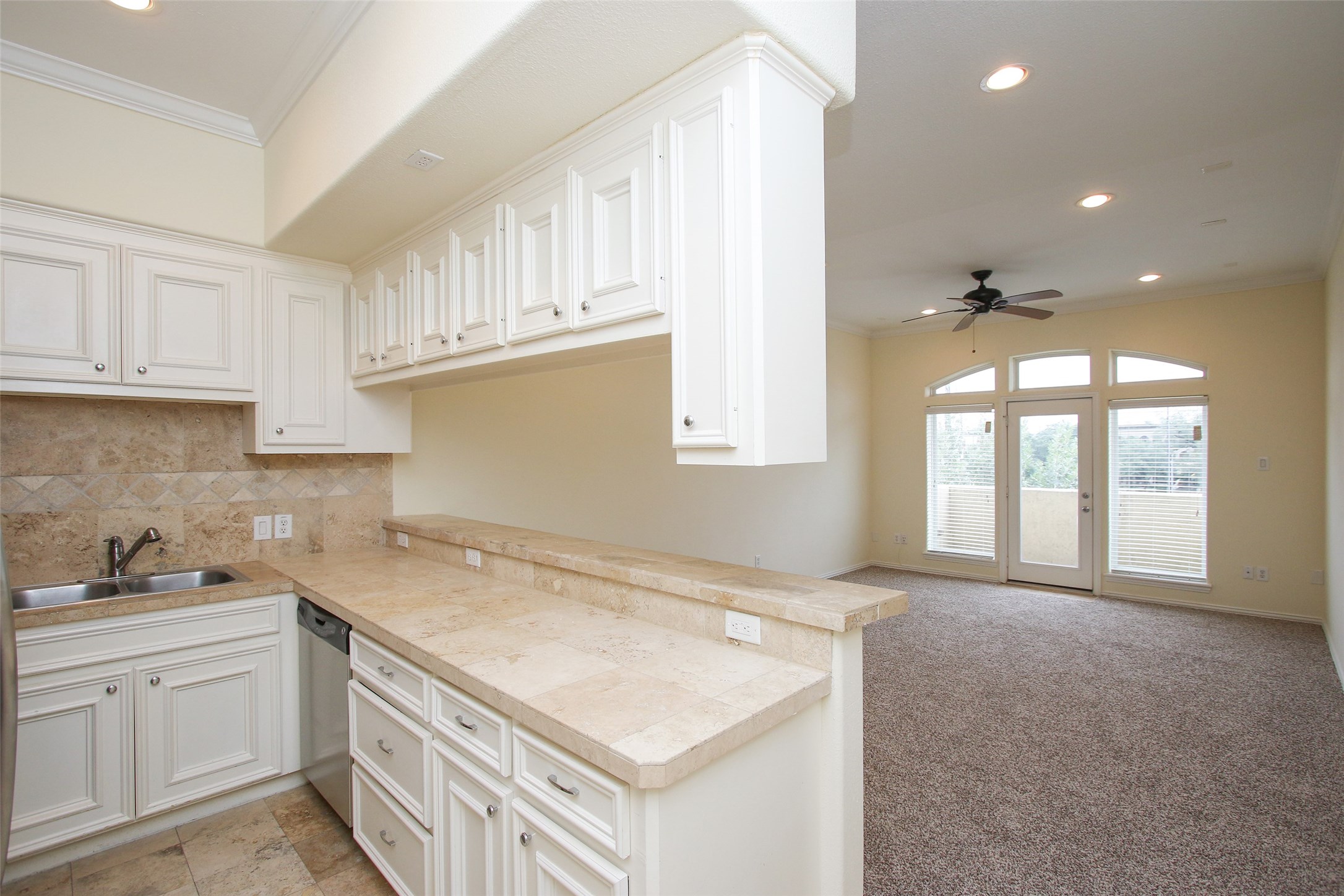 2701 Helena Street, Unit 302 Houston, TX 77006 - Photo 9 of 14 a kitchen that has a lot of cabinets in it with granite countertop a sink