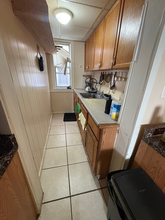 220 East Eagle Street, Unit 3 Boston, MA 02128 - Photo 2 of 6 a kitchen with granite countertop stainless steel appliances a sink a stove a refrigerator and cabinets