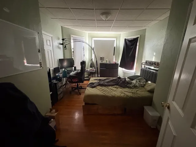 a living room with furniture and a mirror