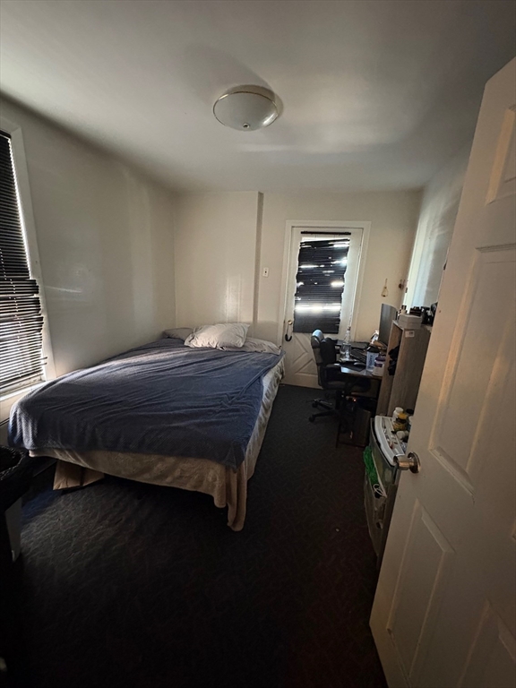 220 East Eagle Street, Unit 3 Boston, MA 02128 - Photo 5 of 6 a bedroom with a bed and wooden floor