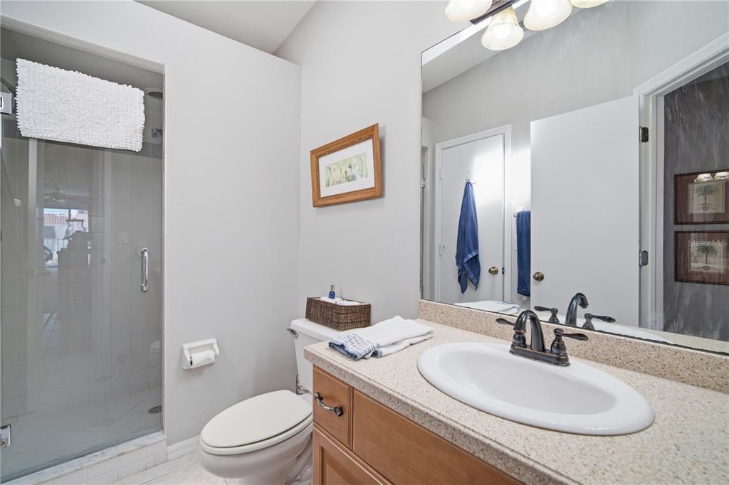 643 Garland Circle Indian Rocks Beach, FL 33785 - Photo 28 of 81 a bathroom with a toilet a sink and a mirror