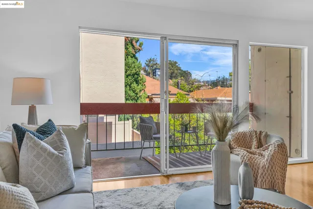 a living room with furniture and a floor to ceiling window