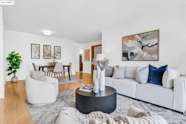 a living room with furniture and a painting