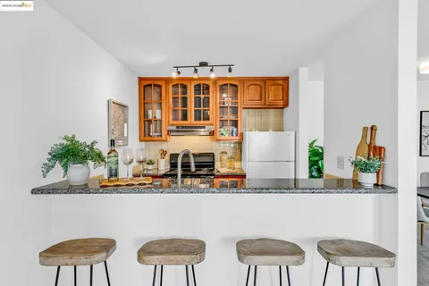 a table with chairs and a vase of flowers on it