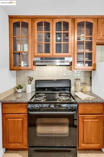 a stove top oven sitting inside of a kitchen