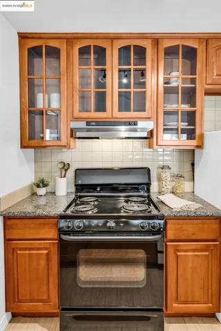 a stove top oven sitting inside of a kitchen