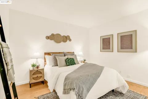 a bedroom with a bed and a painting on the wall