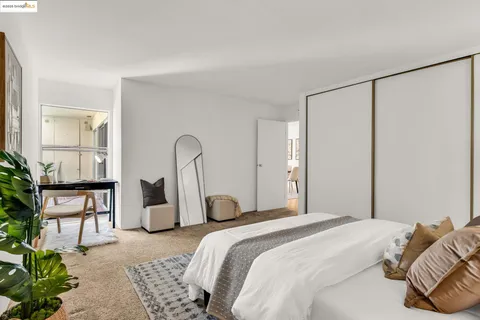 a bedroom with a bed and a potted plant