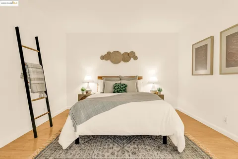 a bed sitting in a bedroom next to a small yard