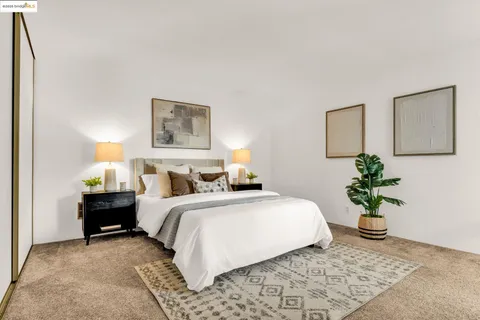 a bedroom with a bed and a potted plant