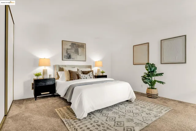 a bedroom with a bed and a potted plant