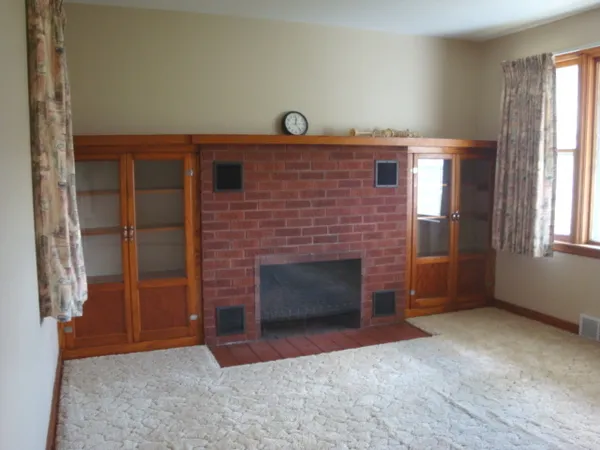 a view of empty room with a fireplace