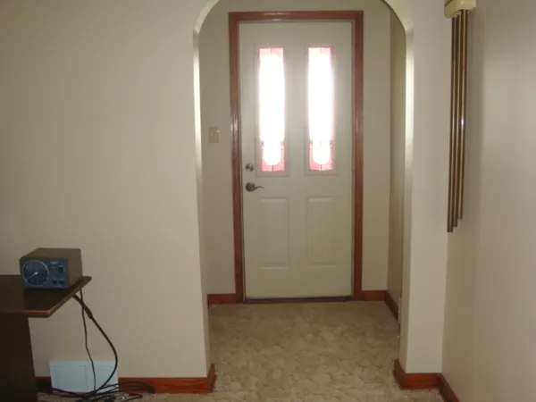 a view of a room with wooden floor and windows